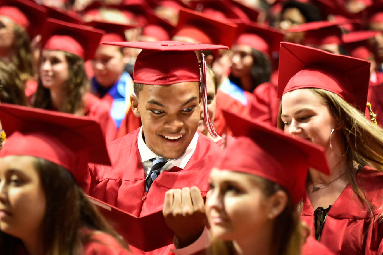 Graduating student, Earnest Brown IV, looks at his diploma with amazement during the Ryan High School Commencement Program at the UNT Coliseum